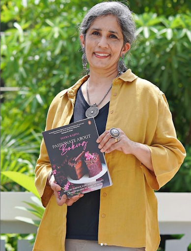  Deeba Rajpal, a food influencer passionate about baking and sharing her recipes. She stands with her Magazine “Passionate about Baking Chocolate”.