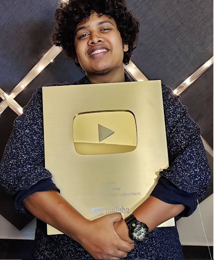 Mohamed Irfan, with his Golden Play Button for achieving 1 million subscribers on his food vlogging channel on YouTube.